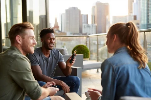Group of friends on a rooftop in Melbourne, discussing their favourite ftp flavour vape options.